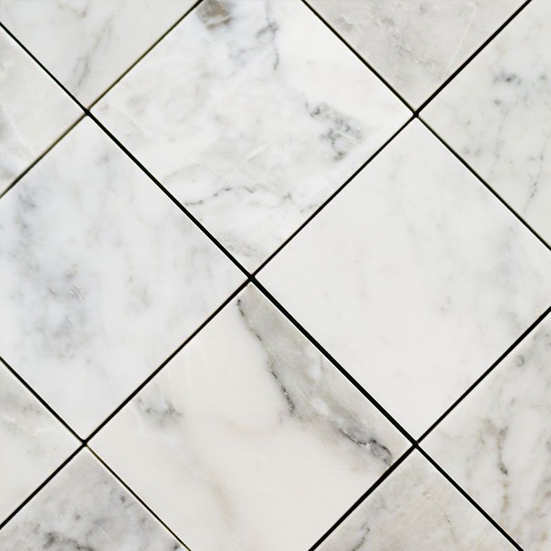 A close up of a marble tile floor with a checkered pattern.