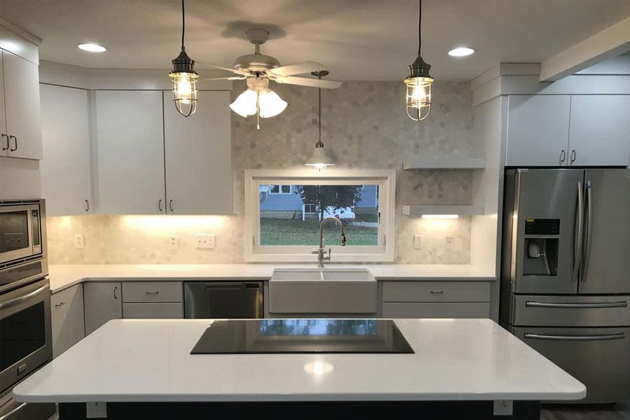 A kitchen with white cabinets and stainless steel appliances