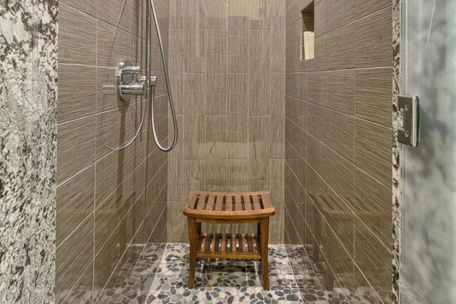 There is a wooden bench in the shower.
