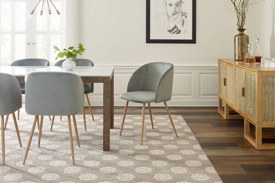 An aerial view of a staircase with a carpeted staircase and a metal railing.