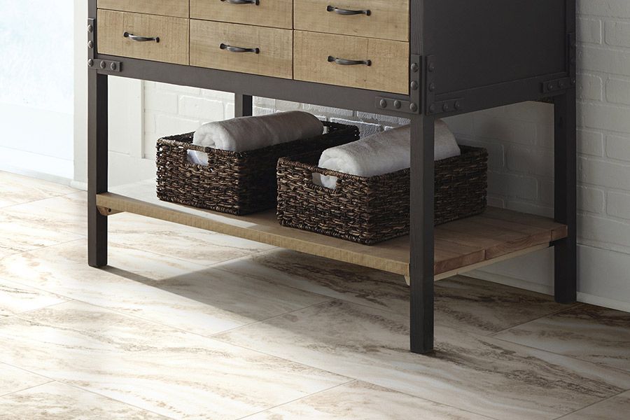 A bathroom vanity with wicker baskets underneath it.