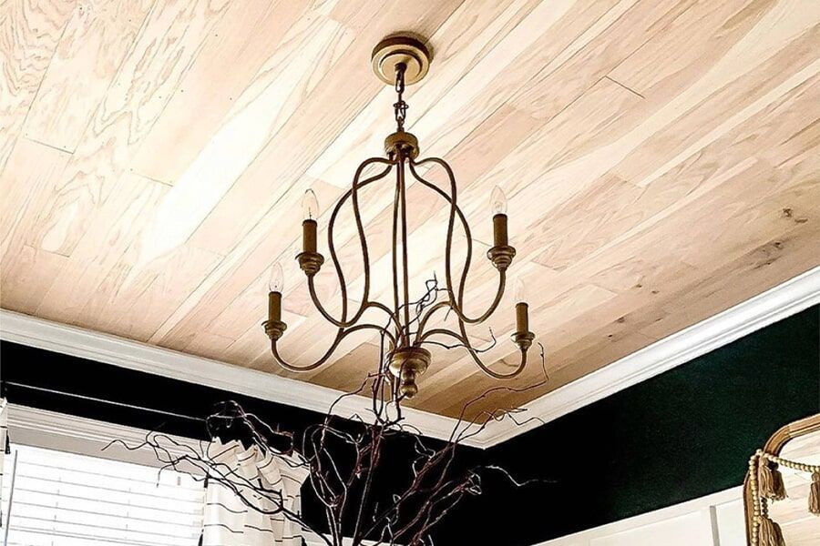 A bedroom with a large clock on the wall above the bed.