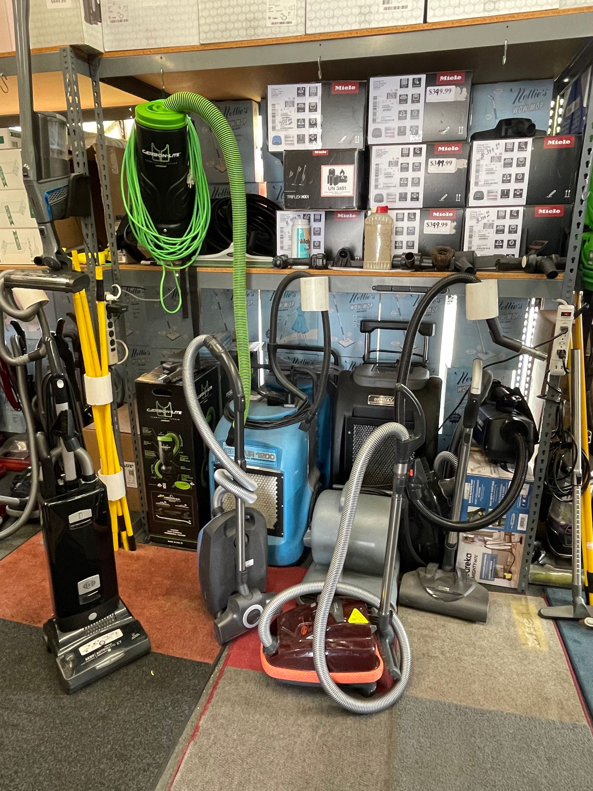 Vacuums and cleaning equipment for sale in a store.