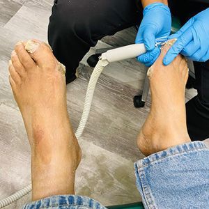 A person with gloves on feet