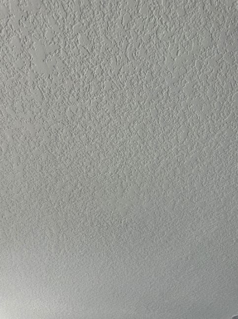 A close up of a white ceiling with a texture.