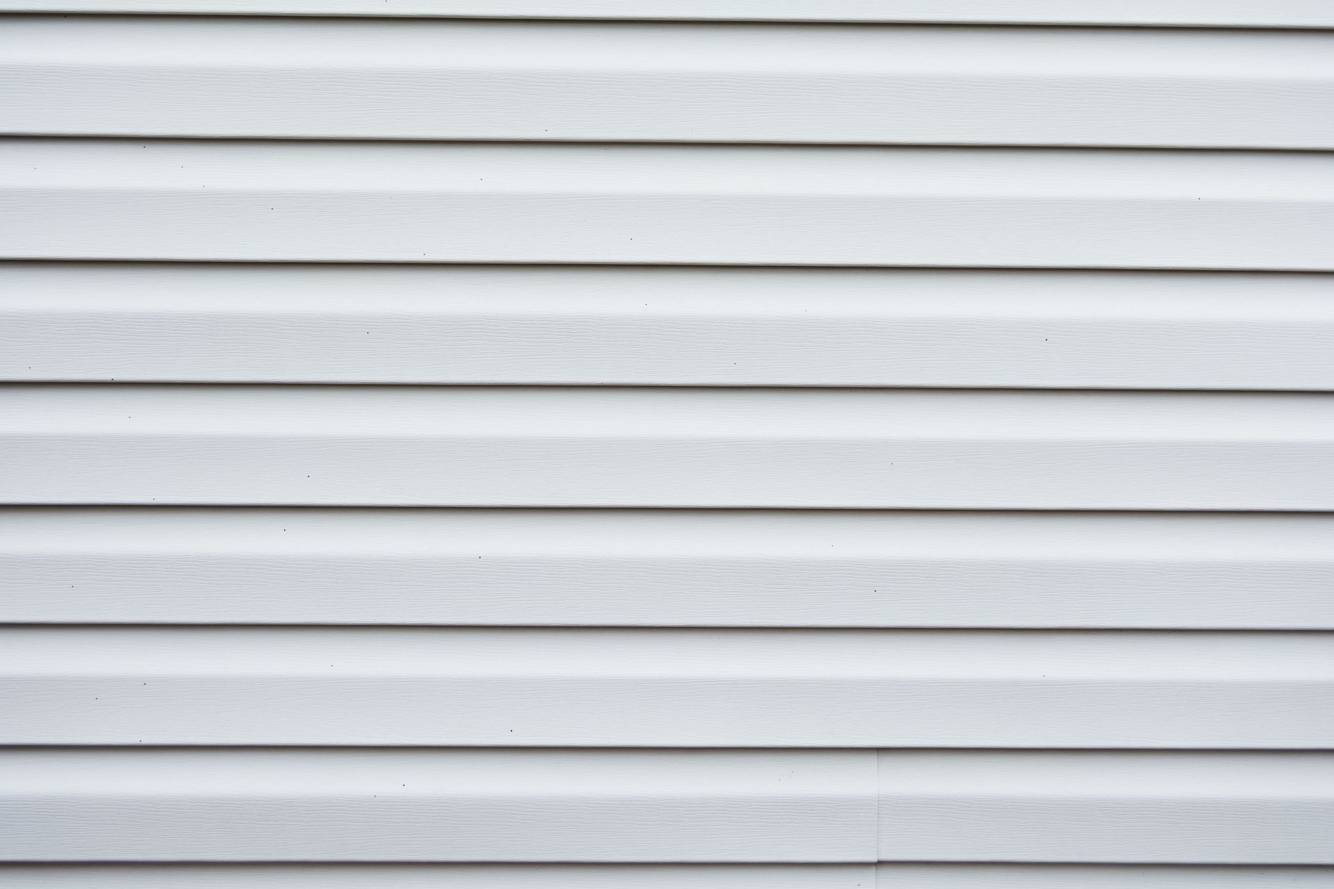 White horizontal vinyl siding with light gray shadows