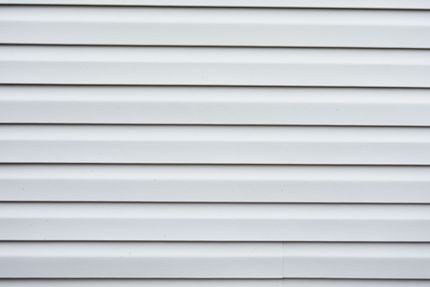 White horizontal vinyl siding with light gray shadows