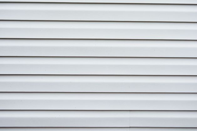 White horizontal vinyl siding with light gray shadows