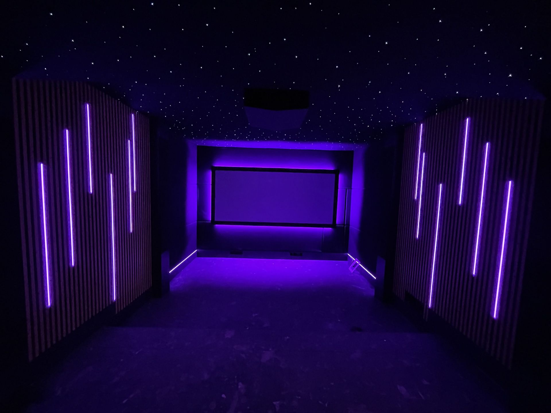 A dark hallway bathed in purple light with glowing neon lines and a starry ceiling.