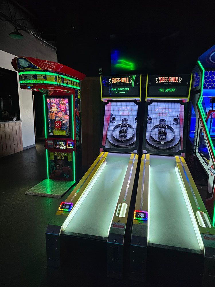 Arcade game machines, illuminated with green and blue lights