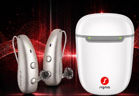 Silver and white hearing aids and charging case on a red background