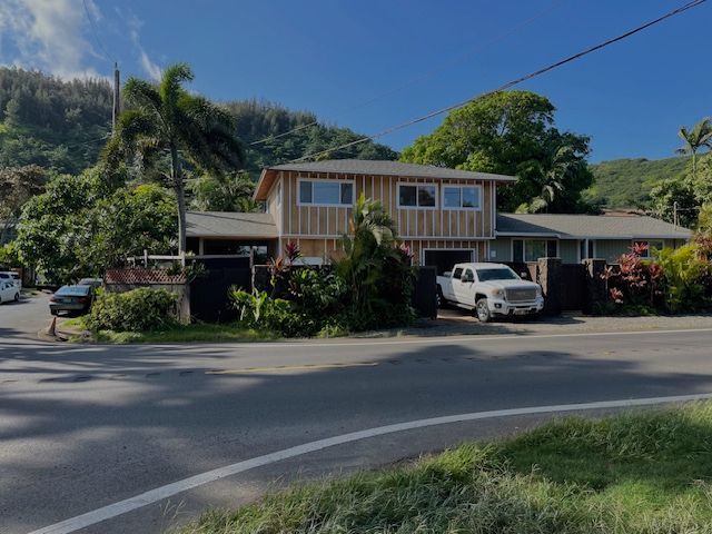 A white truck is parked in front of a house