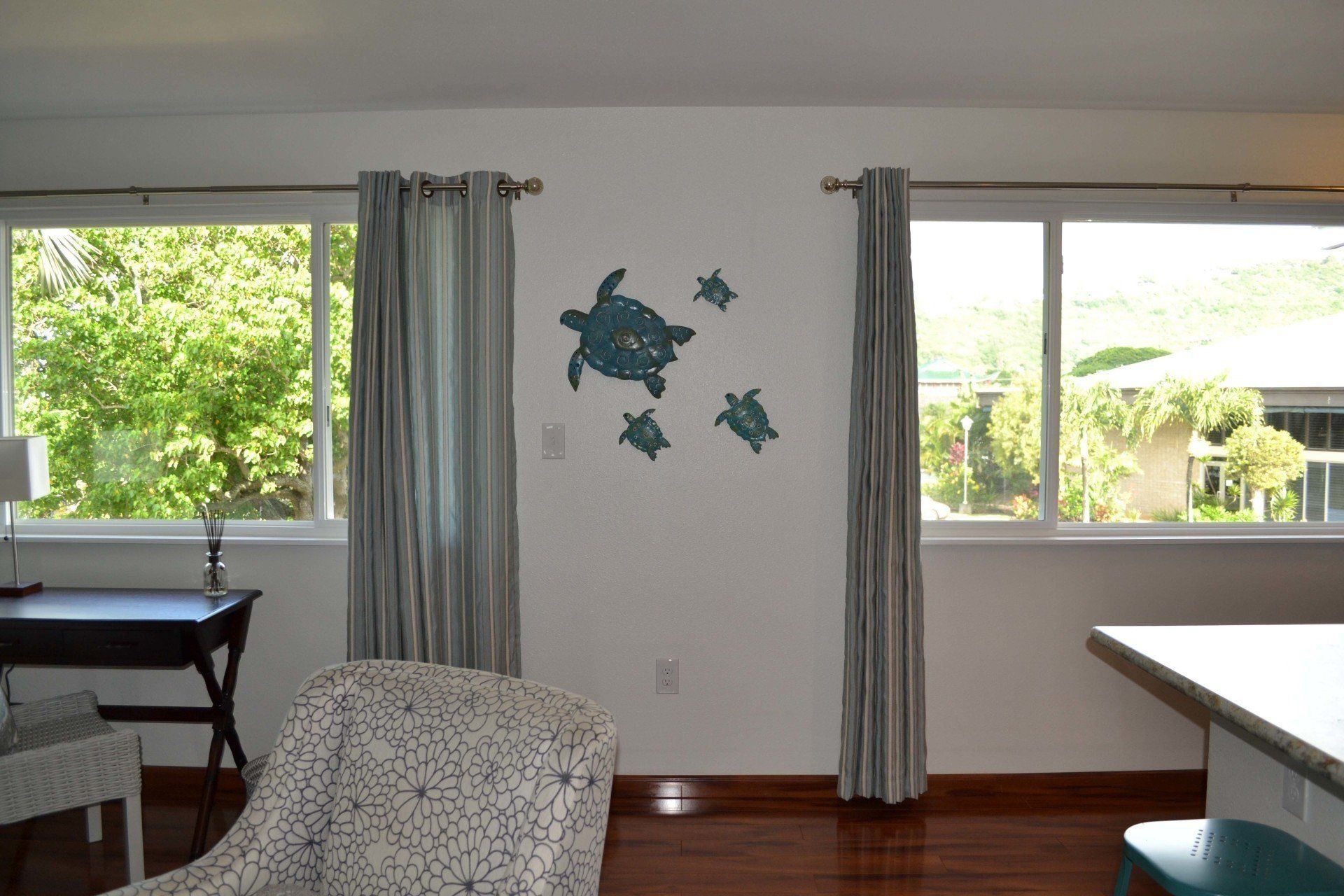 A living room with three sea turtles on the wall