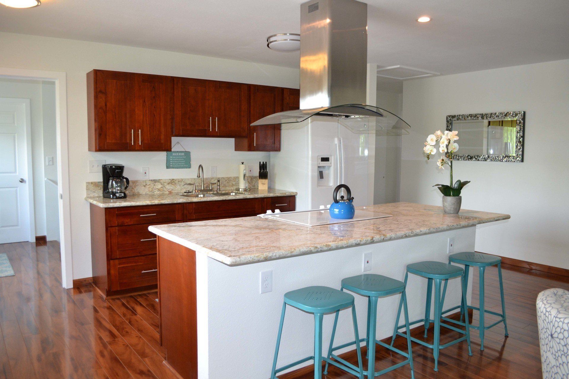 A kitchen with a large island and stools