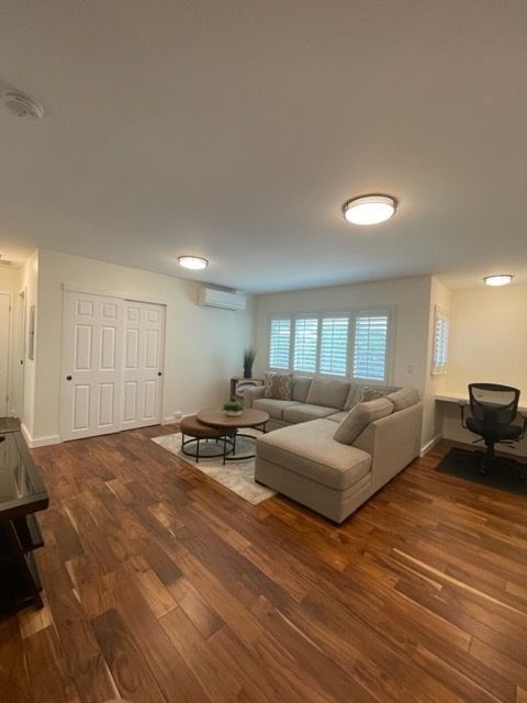 A living room with hardwood floors and a couch.