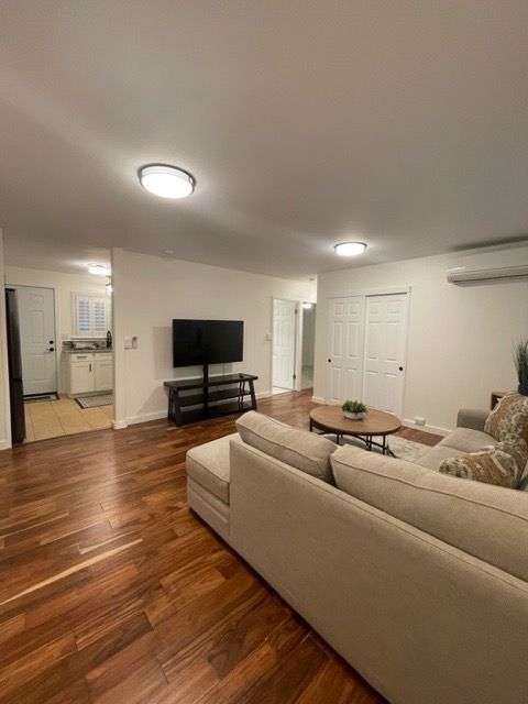 A living room with a couch and a flat screen tv