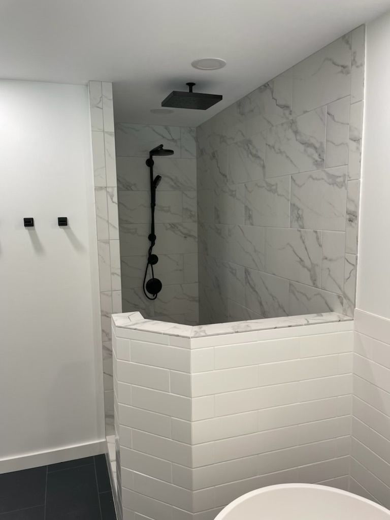 A bathroom with a walk in shower and a bathtub.