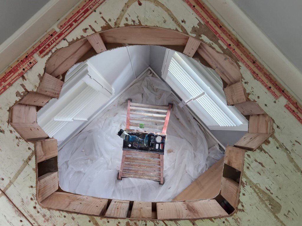 A hole in the ceiling with a chair in it