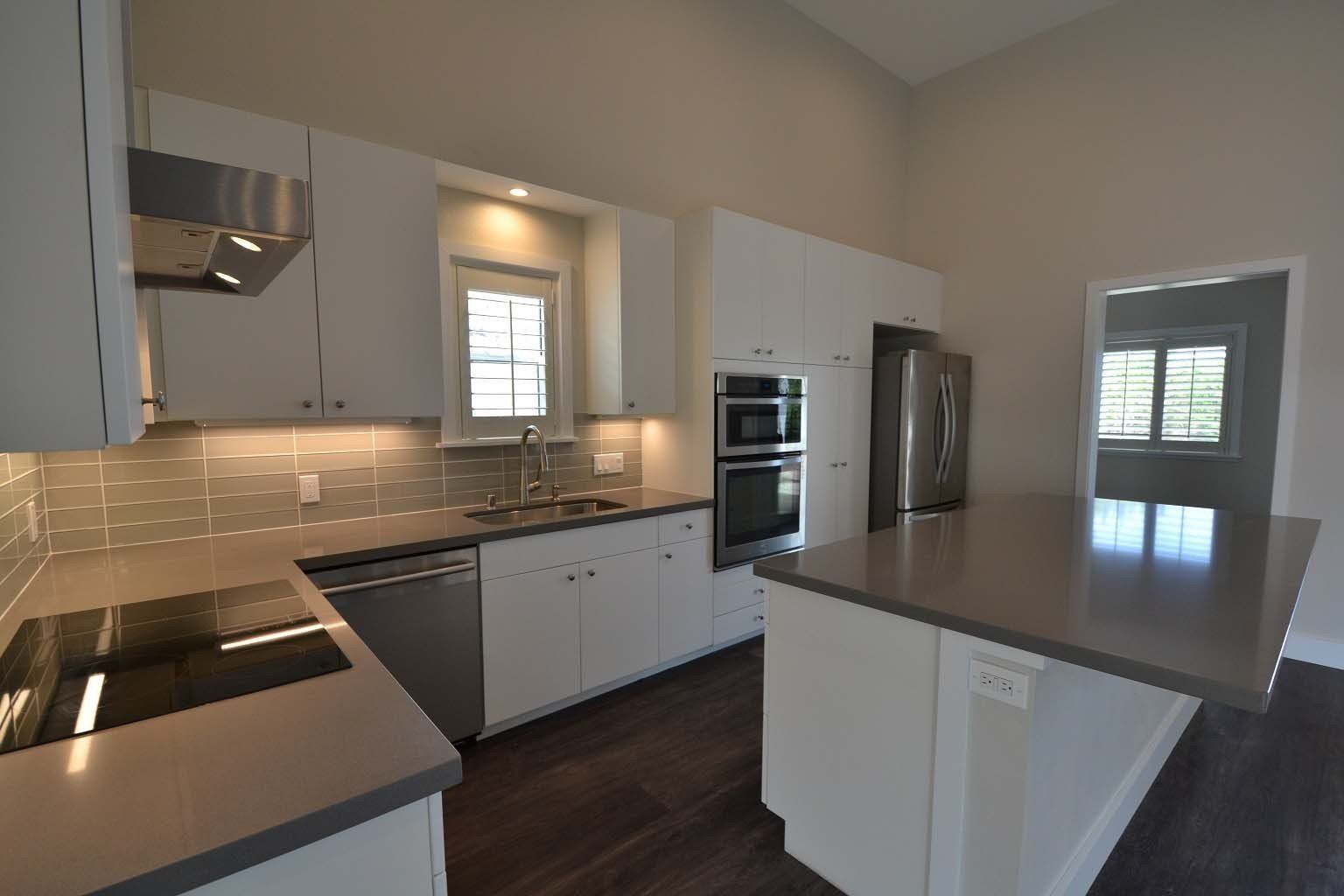 A kitchen with white cabinets and stainless steel appliances