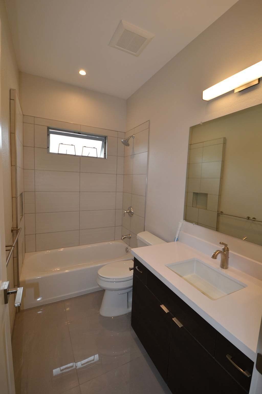 A bathroom with a toilet , sink and bathtub