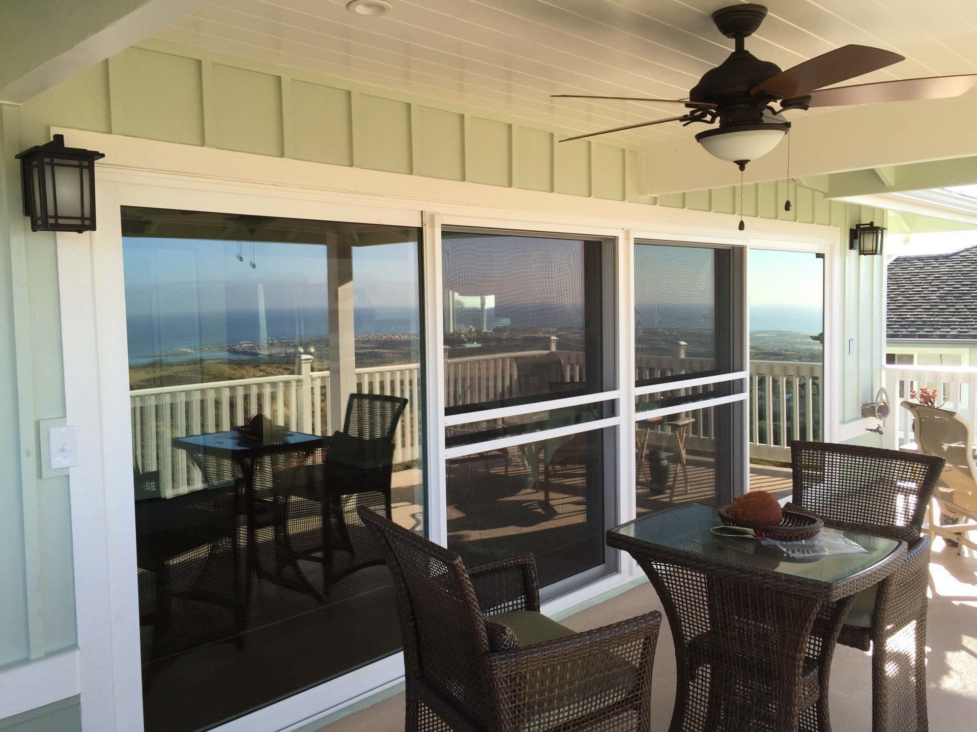 A patio with a table and chairs and a ceiling fan