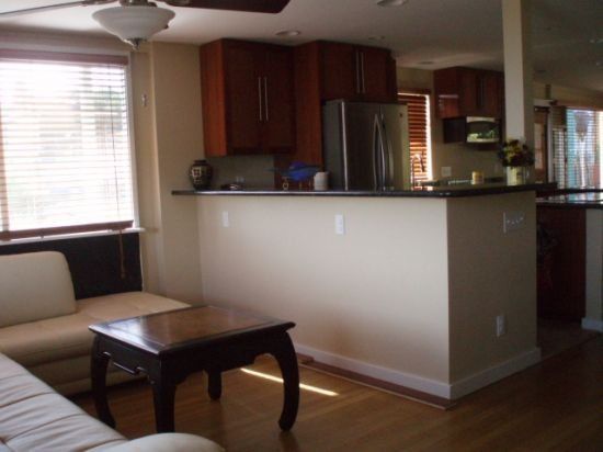 A living room with a couch a table and a ceiling fan