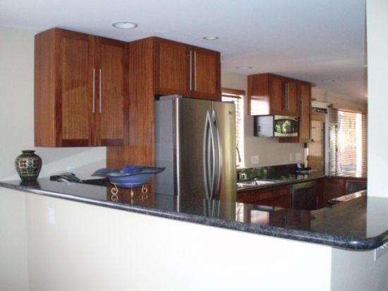 A kitchen with stainless steel appliances and wooden cabinets