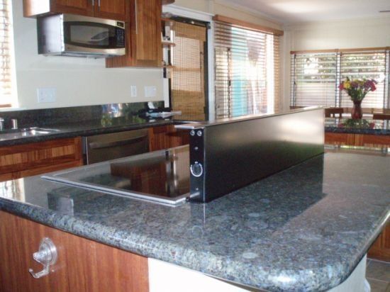 A kitchen with granite counter tops and stainless steel appliances