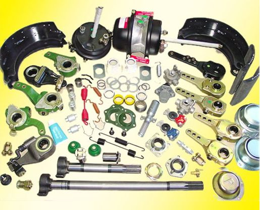 A bunch of different types of parts are laying on a yellow surface.