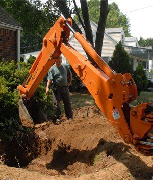 orange tractor digging hole