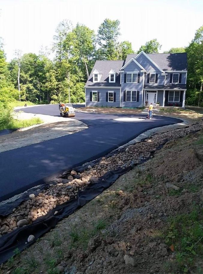 A large house with a large driveway in front of it.