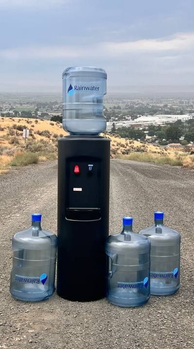 bottled water dispenser and 4 bottles of water