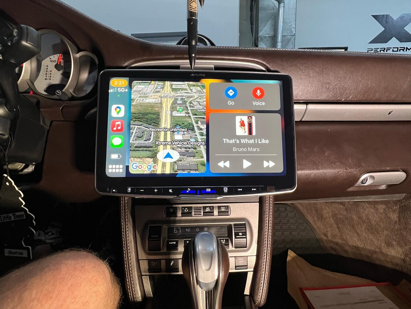 A tablet is mounted on the dashboard of a car