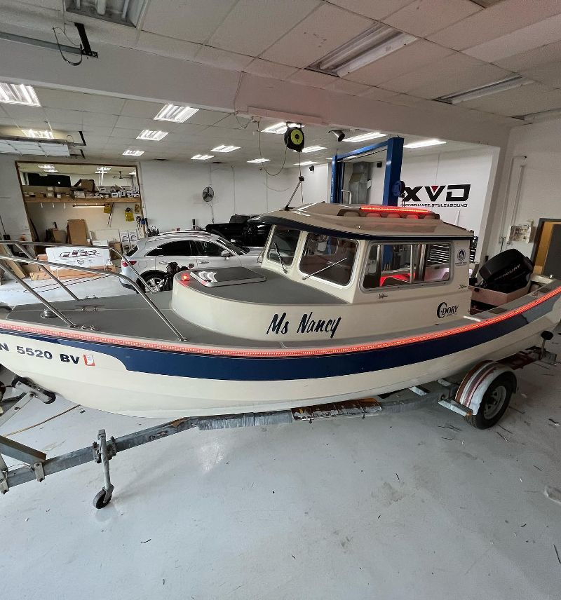 A boat on a trailer with the name mr. fishery on it