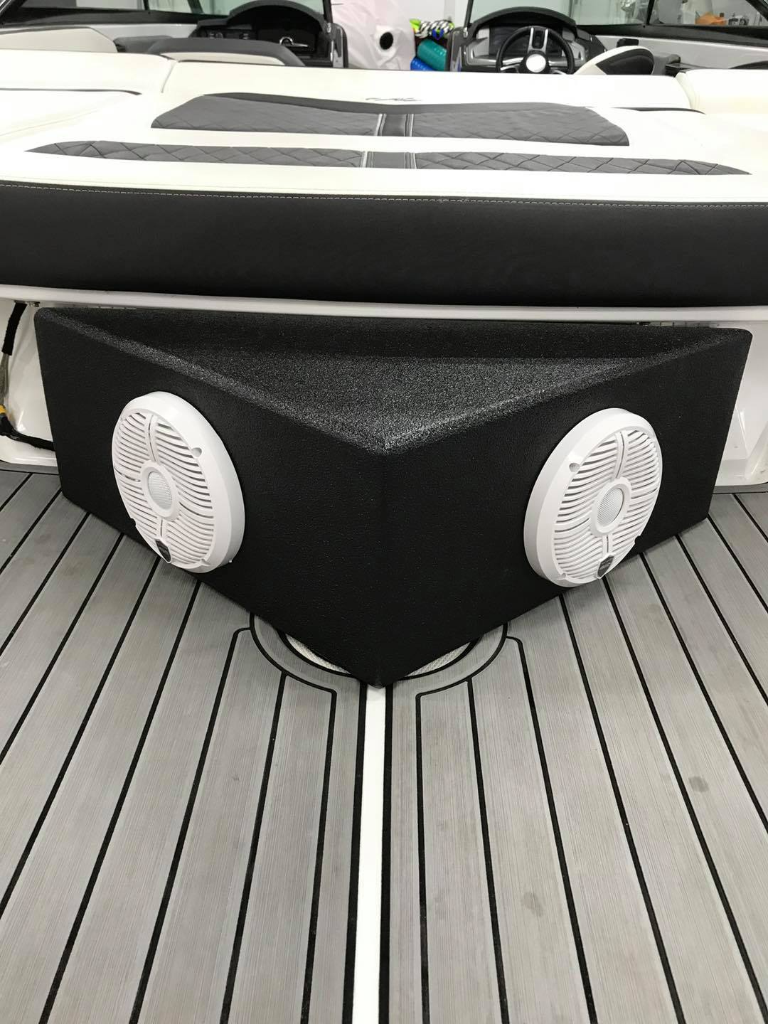 A boat with two speakers on the back of it.