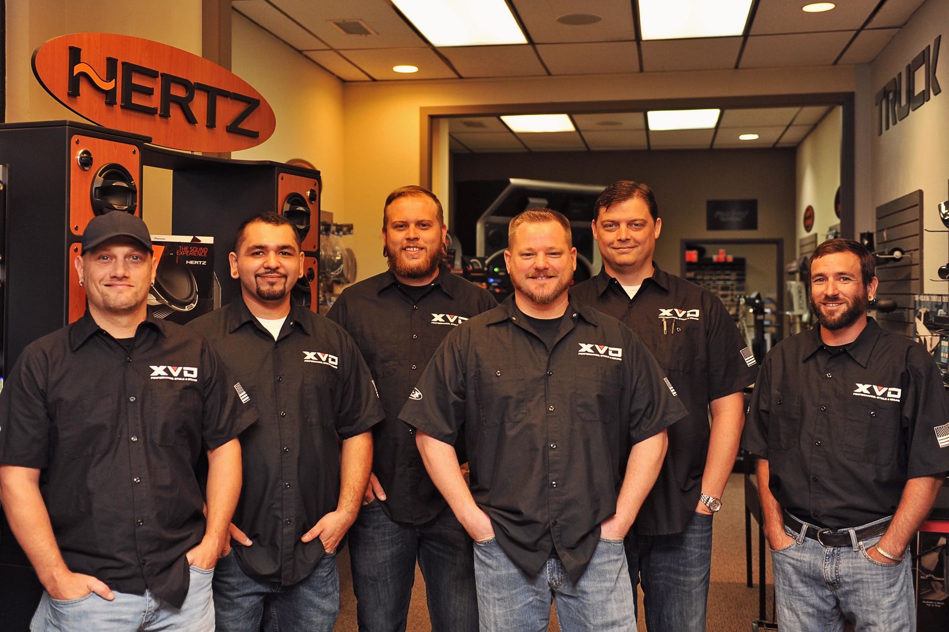 A group of men standing in front of a sign that says nertz
