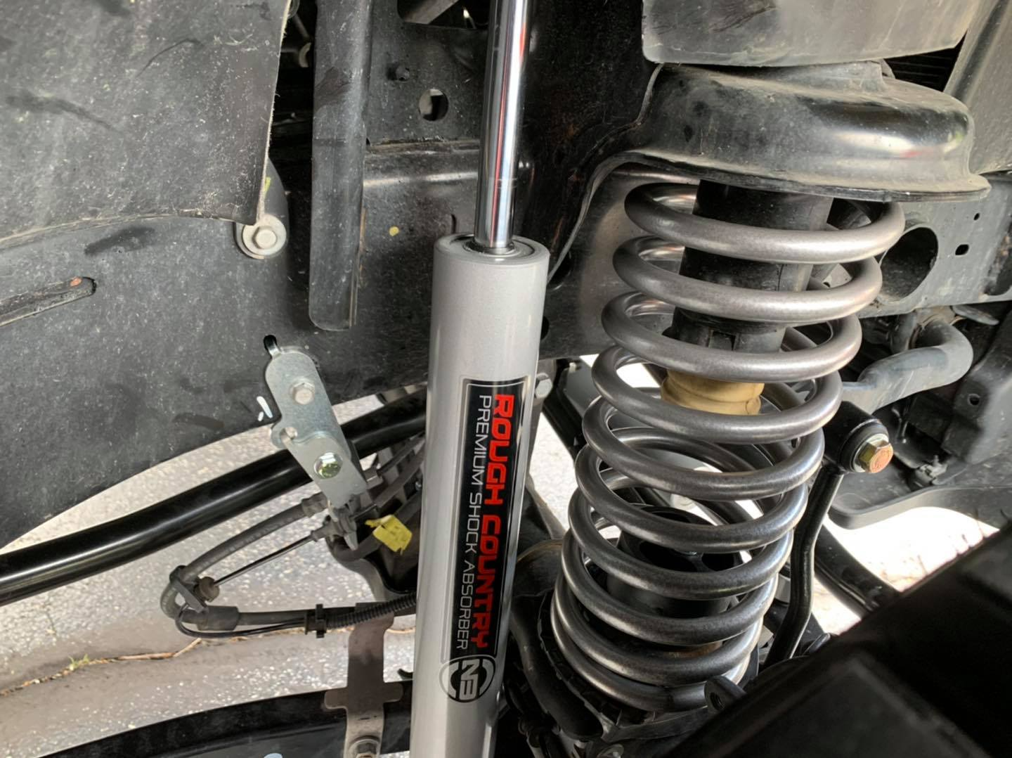 A close up of a shock absorber on a vehicle