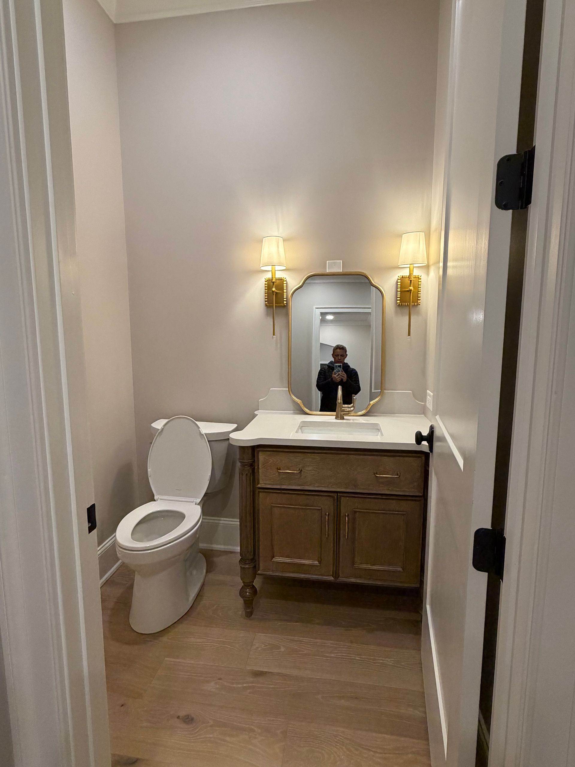 A bathroom with two sinks , a tub , and a large mirror.