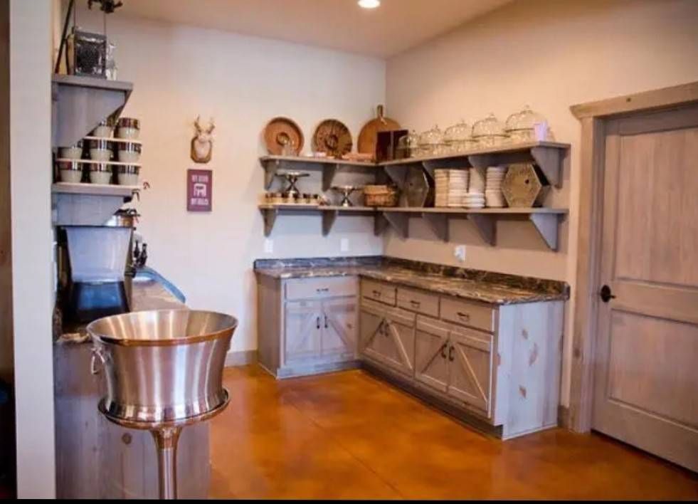 A kitchen with a lot of shelves and cabinets