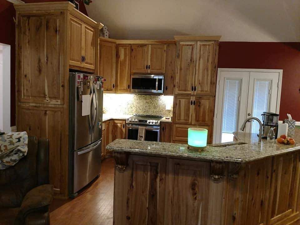 A kitchen with wooden cabinets and stainless steel appliances
