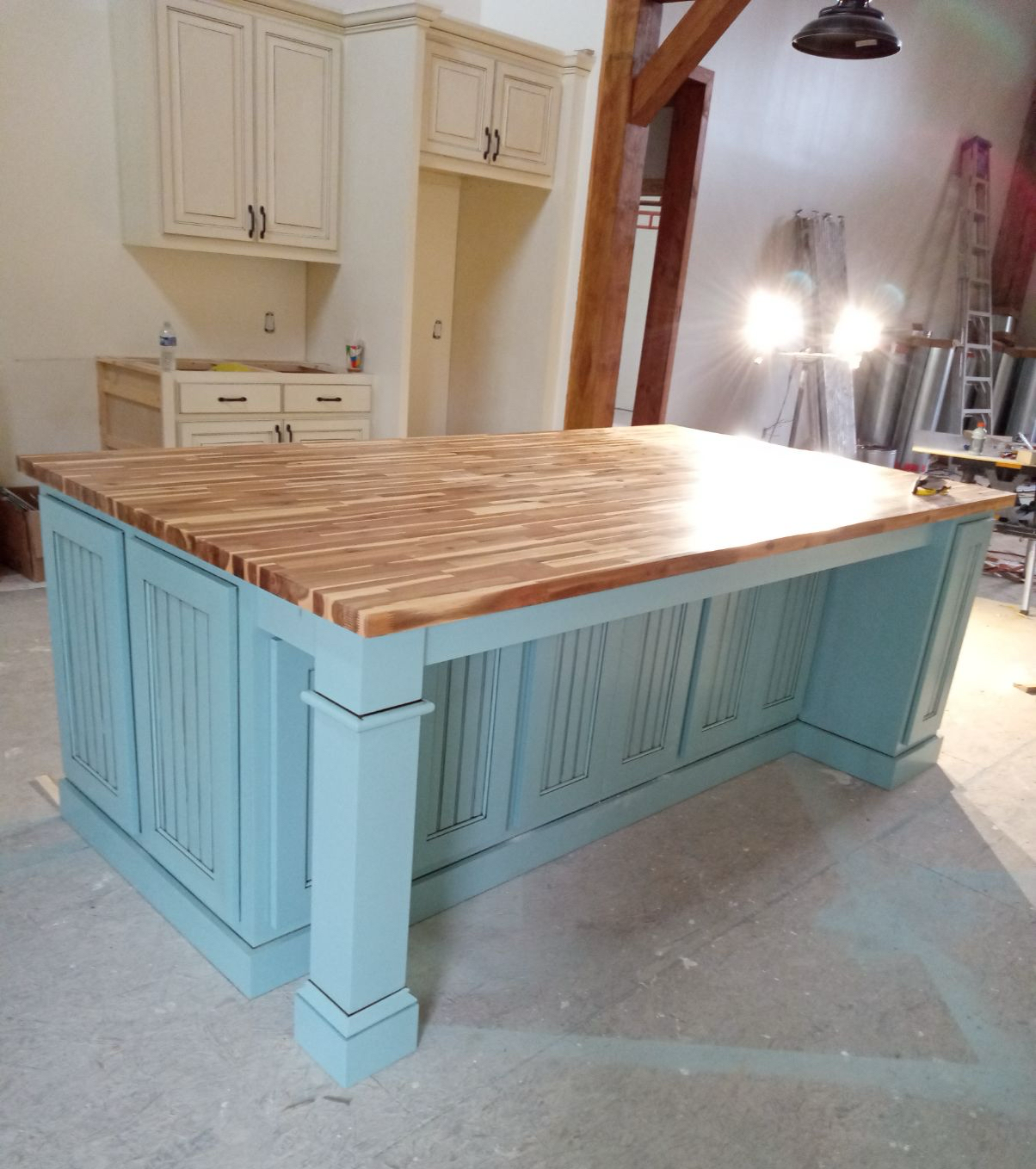 A kitchen island with a wooden top and blue cabinets