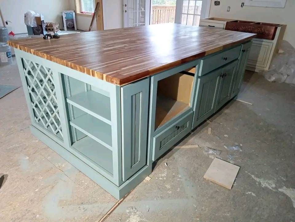 A kitchen island with a wooden top and drawers