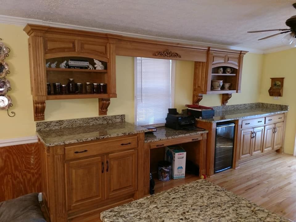 A kitchen with wooden cabinets and granite counter tops