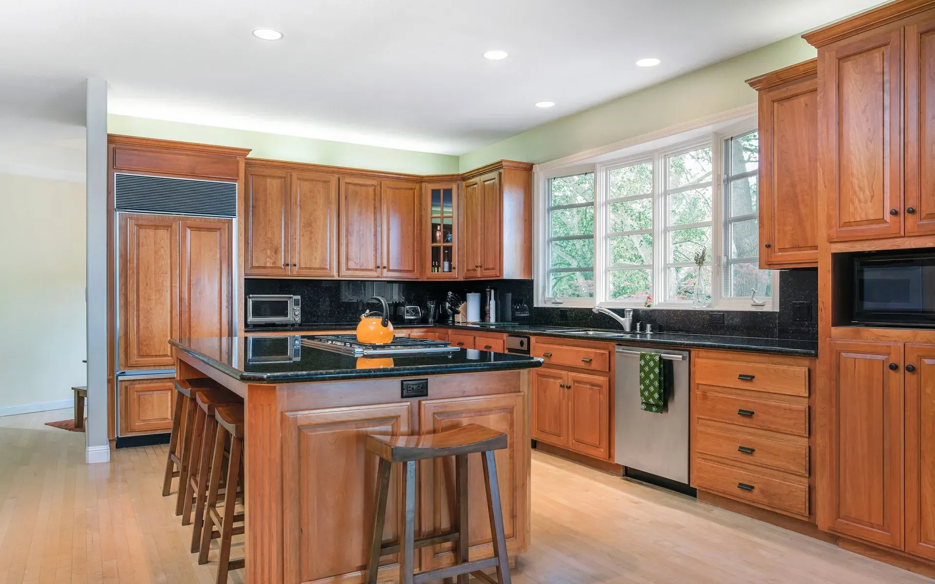 A large kitchen with wooden cabinets and stainless steel appliances