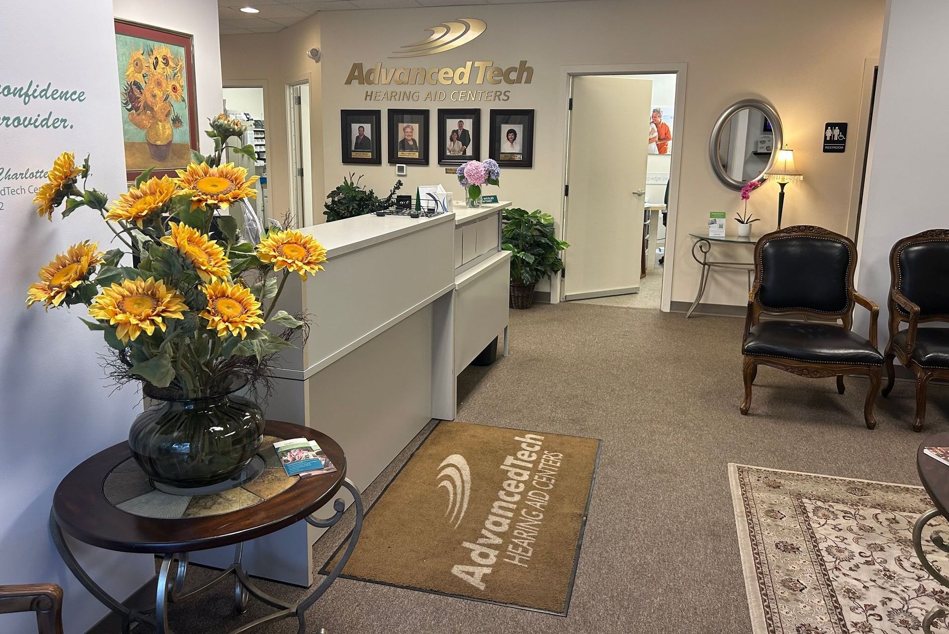 A waiting room with a table and chairs and a rug that says adrienne medical