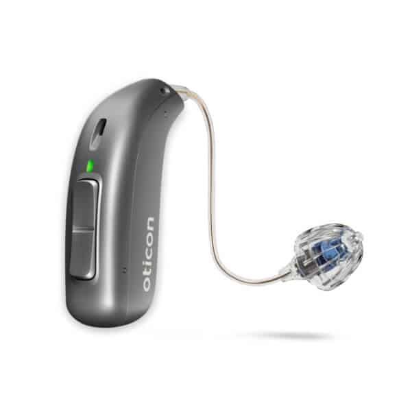 An oticon hearing aid is sitting on a white surface.