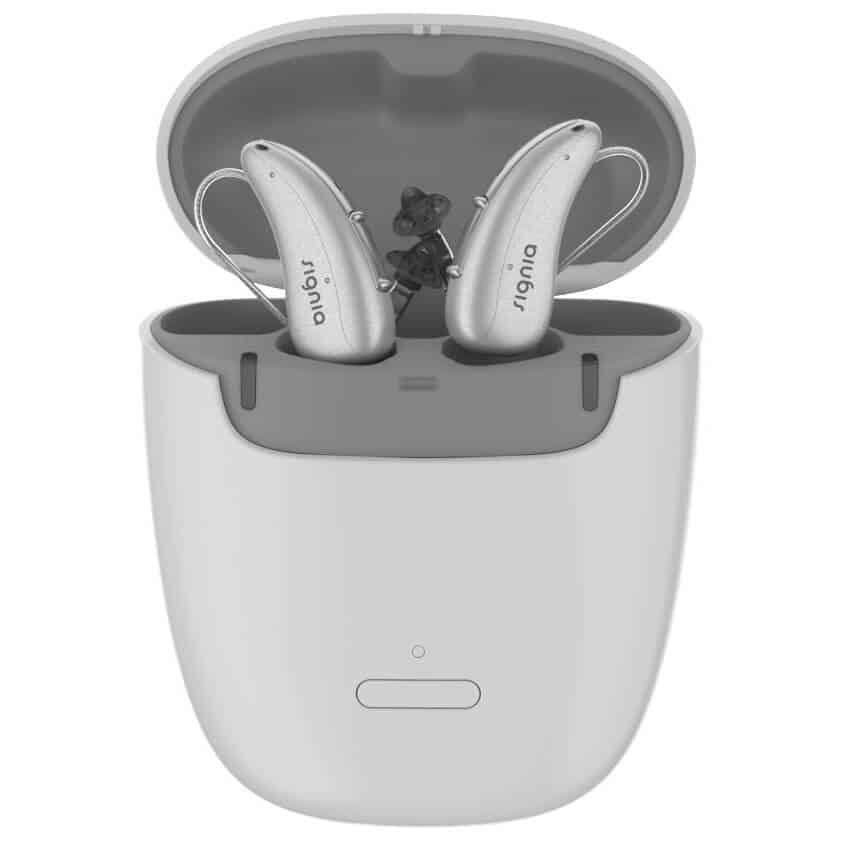 A pair of hearing aids in a charging case.