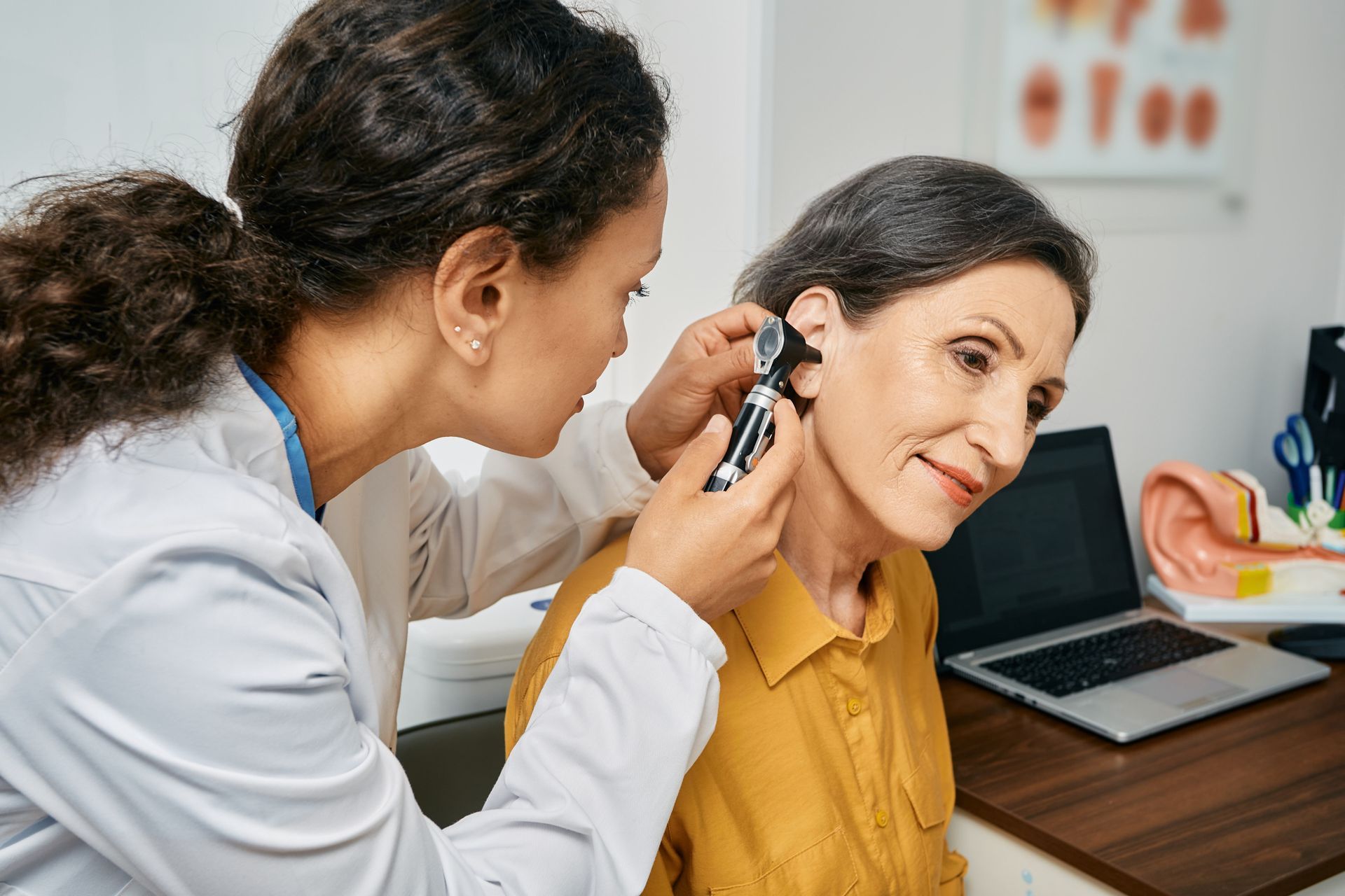 Dr examining a patients ear.