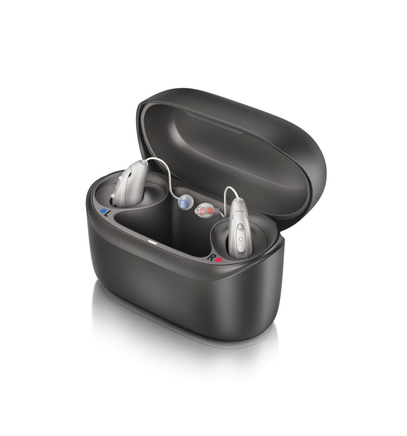 A group of hearing aids are lined up in a row on a white surface.