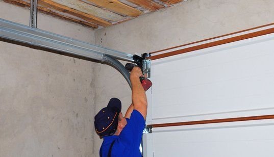 man installing garage door